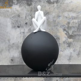 A white abstract figure seat on a black sphere for outdoor DZM 104