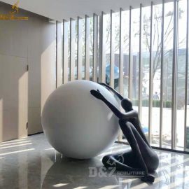 a black abstract figure man seat with a white ball for sale DZM 105