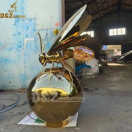 A golden bee is flying on the ball stainless steel sphere and animal for sale DZM 961