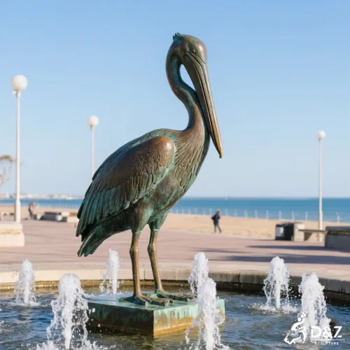 Giant bronze pelican statue with vintage green patina finish as a garden water feature focal point.