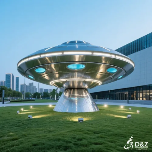 LED light sculpture ufo with neon blue accents and reflective stainless steel surface.