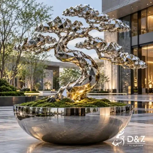 Stainless steel tree sculpture with geometric bonsai form displayed in a modern outdoor commercial plaza