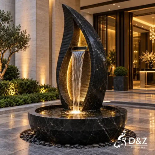 Large black stone fountain with grooved design, water curtain and LED lighting at a luxury hotel entrance Large black stone fountain with grooved design, water curtain and LED lighting at a luxury hotel entrance