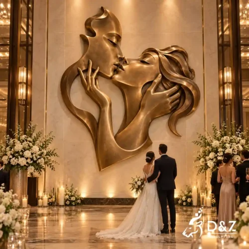 Large bronze kiss wall sculpture with romantic kissing couple and hands for a luxury wedding venue