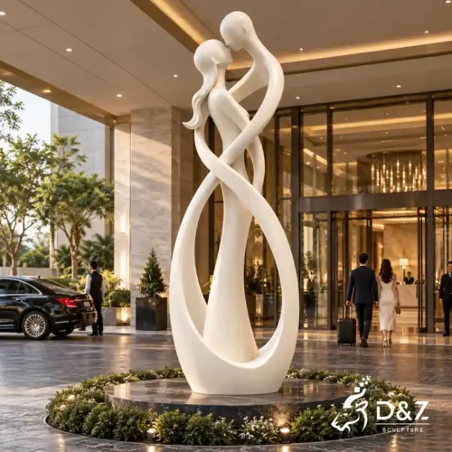 The kiss abstract sculpture in white stainless steel at a luxury hotel entrance
