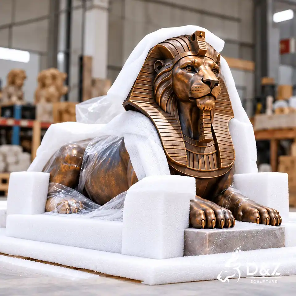 Bronze Egyptian lion statue cushioned with protective foam and clear plastic wrapping inside a sculpture workshop Bronze Egyptian lion statue cushioned with protective foam and clear plastic wrapping inside a sculpture workshop